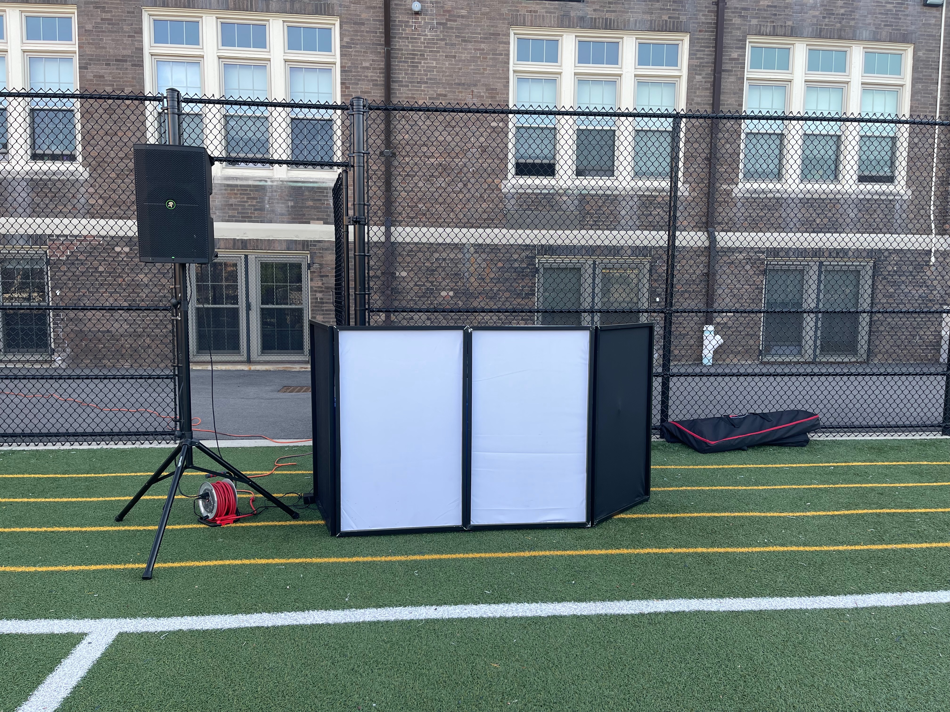 DJ setup outdoors on a sports field